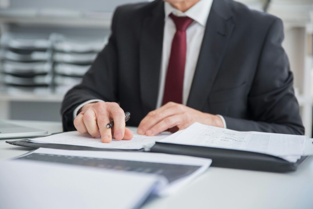 Business professional reviewing documents at a desk, representing specialist content evaluation and expert analysis