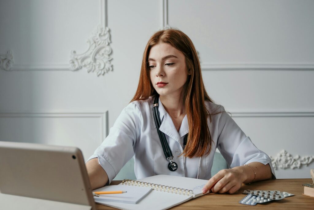 A female medical healthcare content creator looking at a computer.
